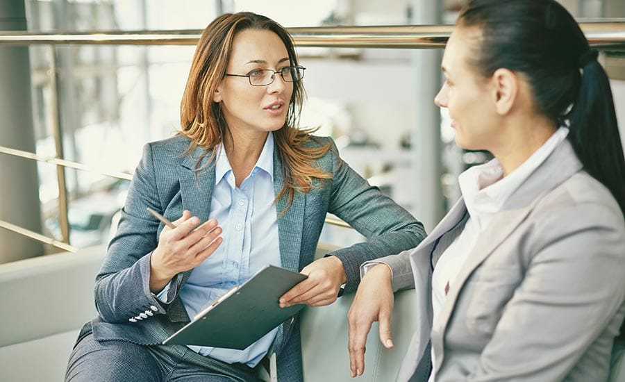 A manager talking to an employee during the onboarding process​