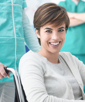 stock-photo-smiling-patient-receiving-a-medical-consultation-and-looking-at-camera-the-female-doctor-is-606777308 1