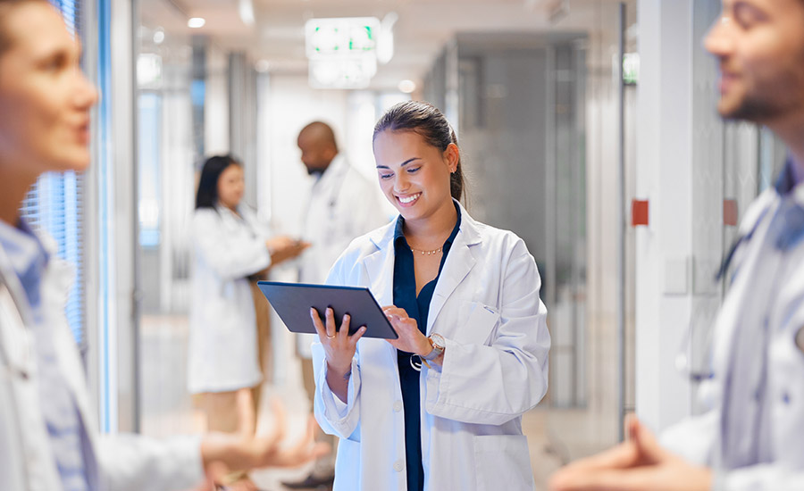 A doctor in a hospital looking at a tablet​