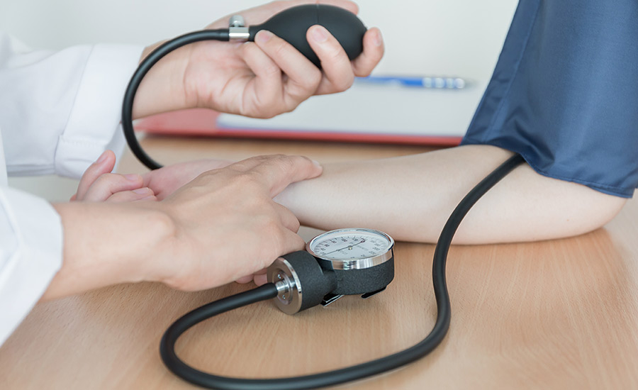 A doctor  measuring a patient