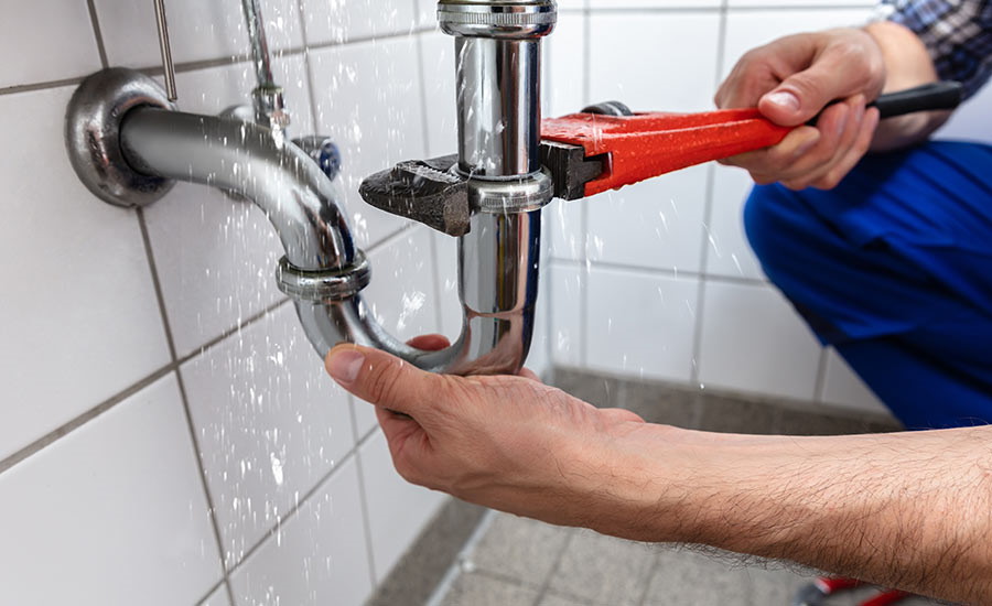 A plumber fixing a problem in the bathroom