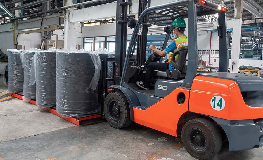 An image showing a man operating a forklift