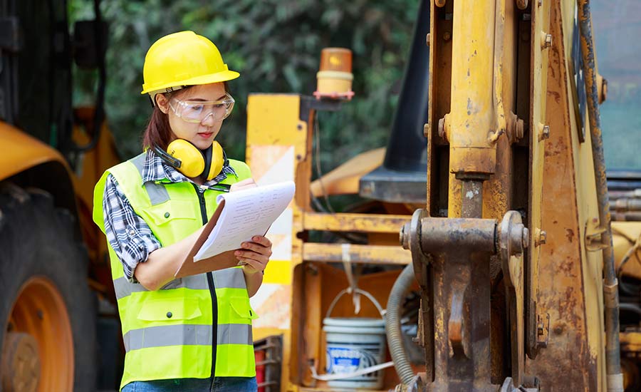 A construction employee holding a checklist