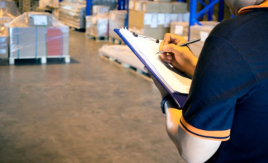  A warehouse employee holding a checklist