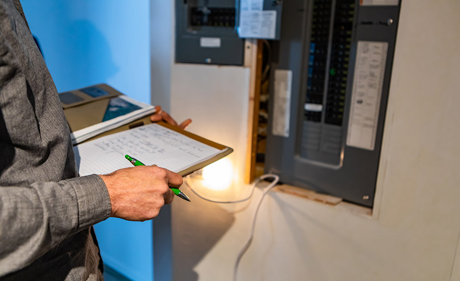 An electrical inspector checking an electric distribution board