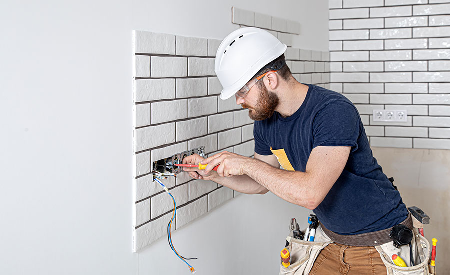 A licensed electrician fixing a socket