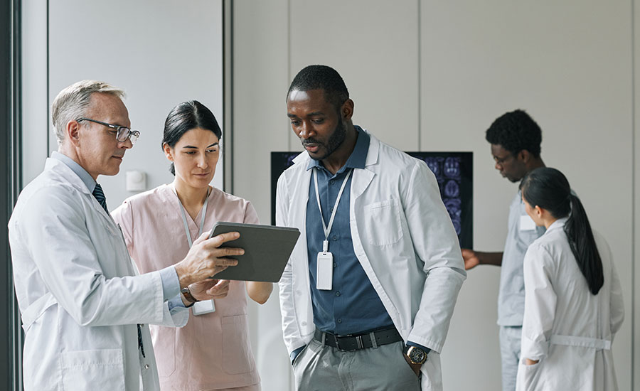 A group of doctors looking at a tablet