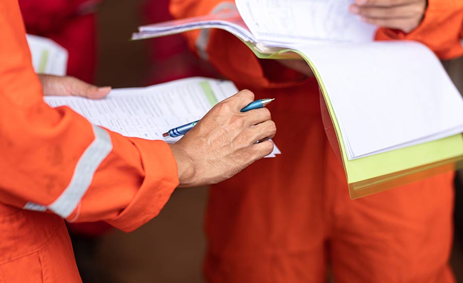 An image of employees filling out an incident report