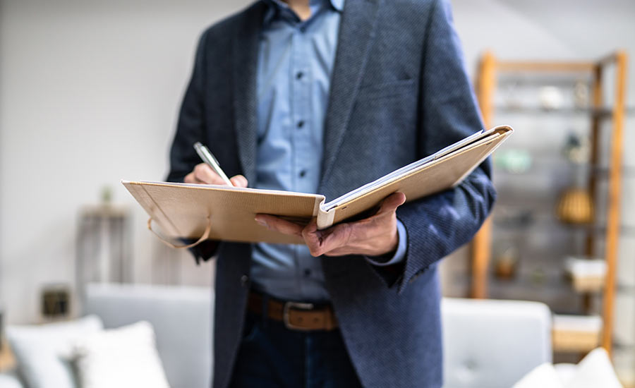 An FHA inspector documenting inspection findings