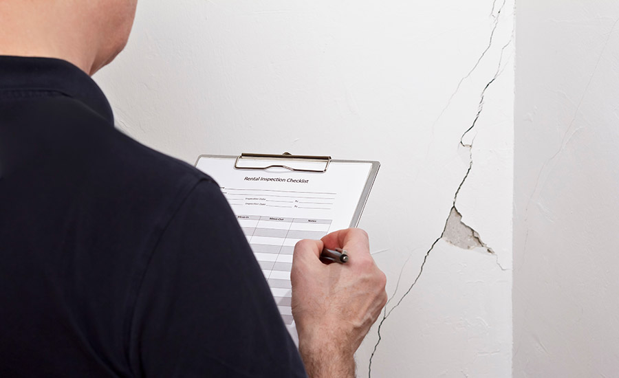 A termite inspector writing down his findings​