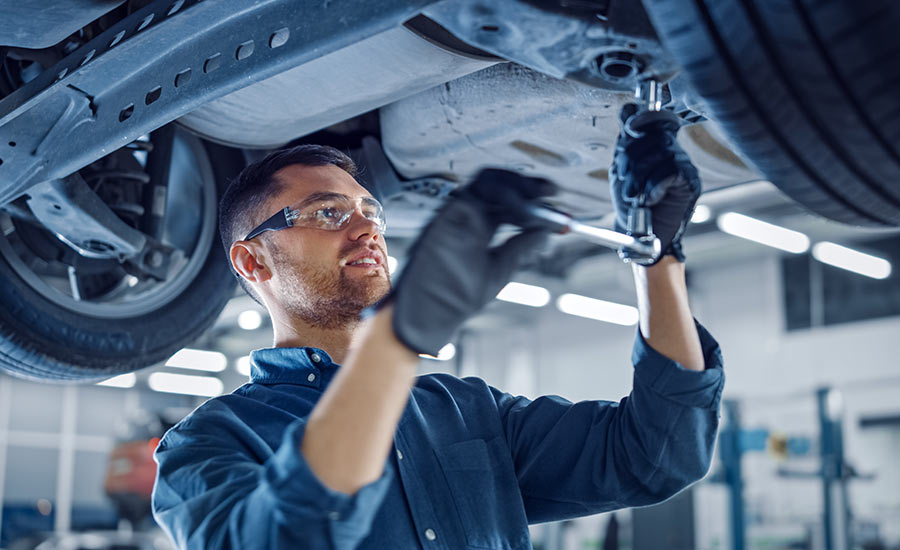 A mechanic servicing a vehicle​