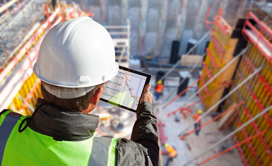 An engineer with a tablet at a construction site​