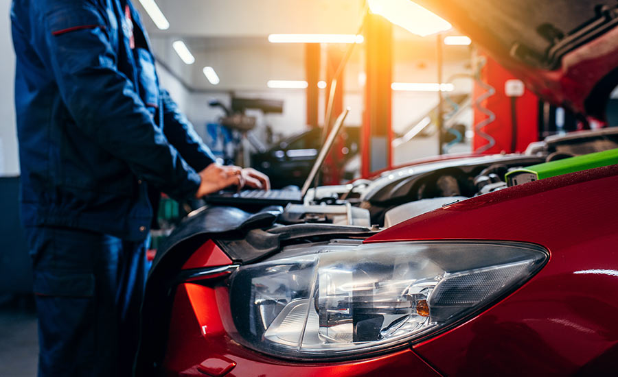 A technician checking a car engine​