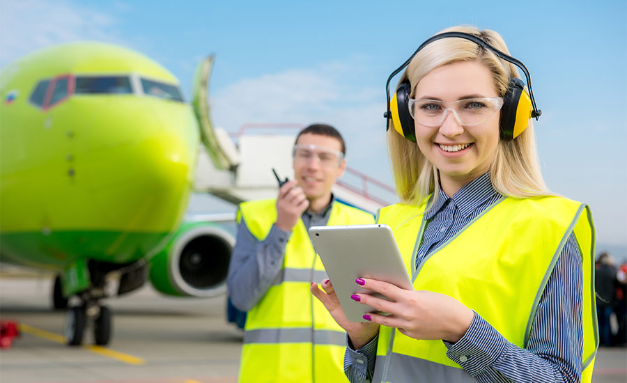 Airport workers next to an airplane​