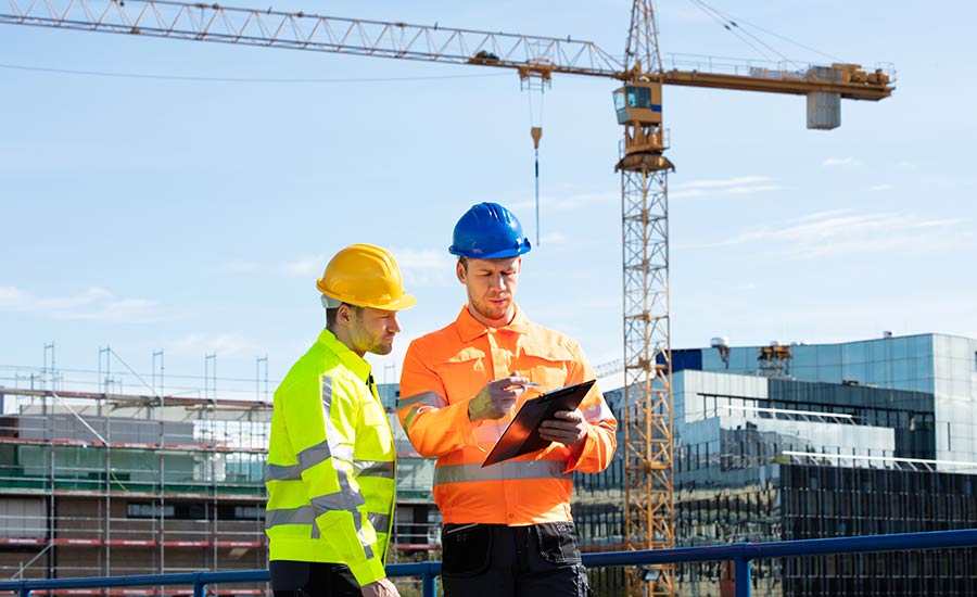 Two men conducting a construction site safety inspection​