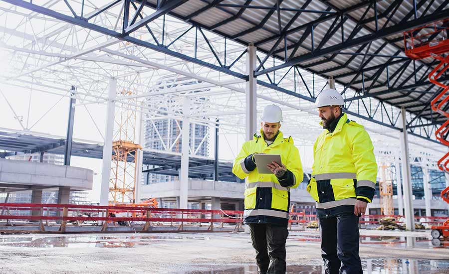 Construction safety inspectors with a tablet​