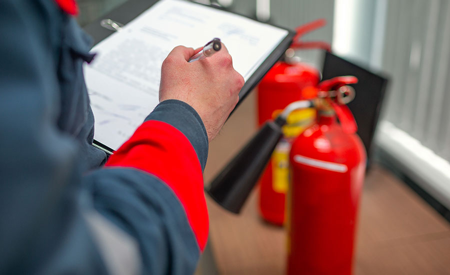 A fire inspector checking fire extinguishers​
